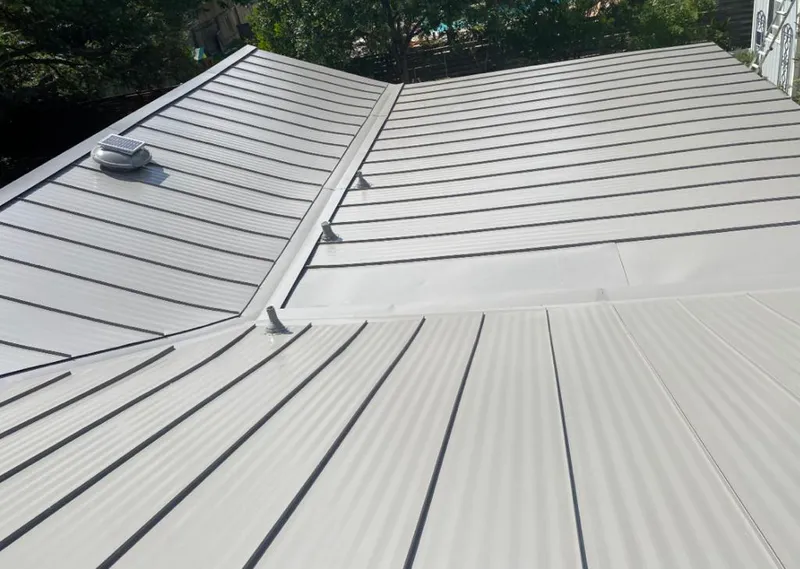 Solar attic fan installed on a metal roof for Roof Ventilation in Highlands